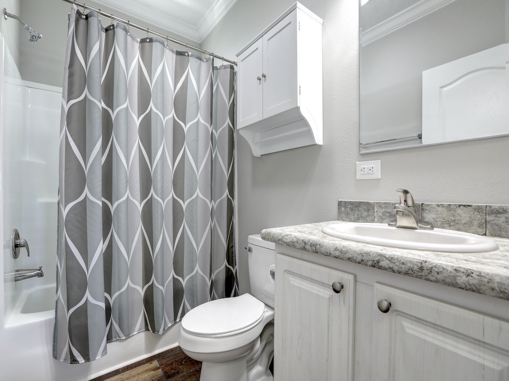 1011 Barefoot Circle Barefoot Bay, FL 32976 - Photo 18 of 31 a bathroom with a granite countertop sink and a mirror