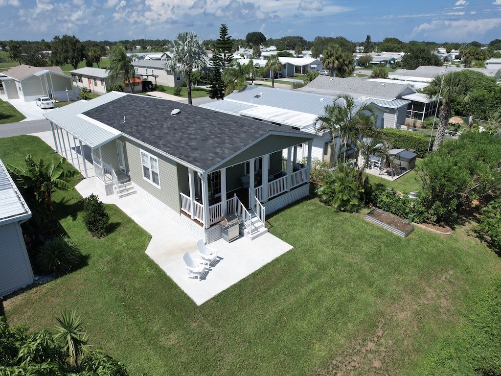 1011 Barefoot Circle Barefoot Bay, FL 32976 - Photo 23 of 31 an aerial view of a house with a garden