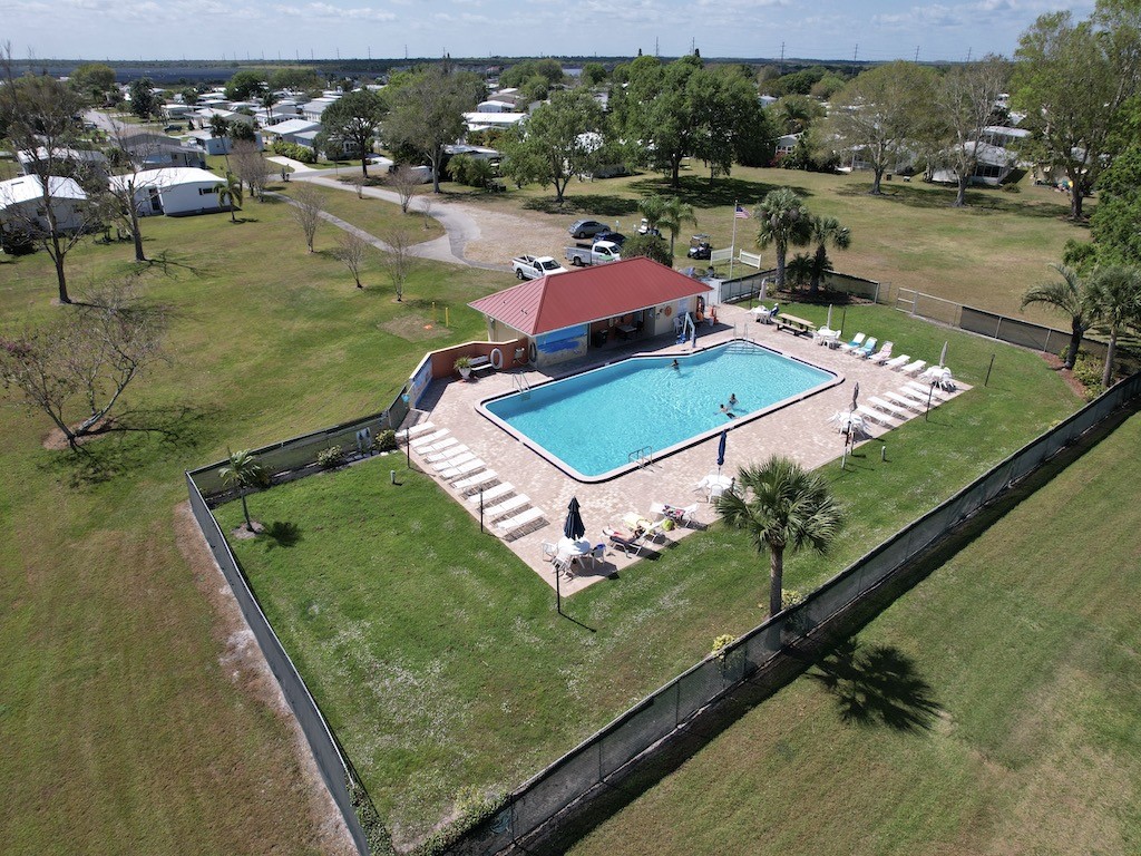 1011 Barefoot Circle Barefoot Bay, FL 32976 - Photo 29 of 31 an aerial view of a golf course with chairs