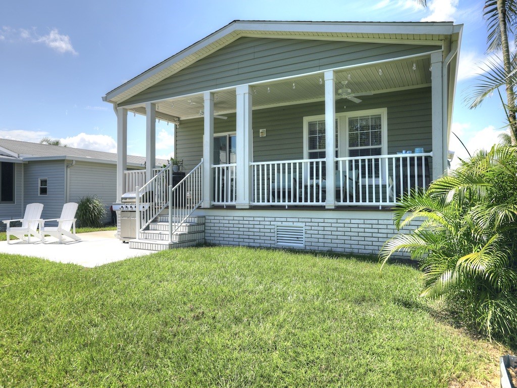 1011 Barefoot Circle Barefoot Bay, FL 32976 - Photo 3 of 31 a view of a house with backyard and sitting area
