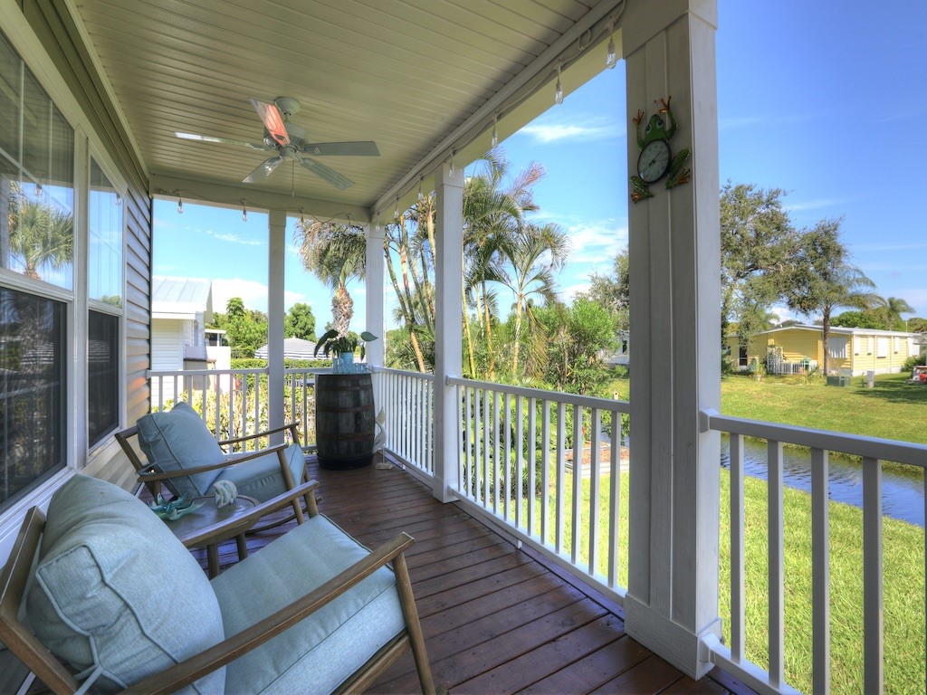 1011 Barefoot Circle Barefoot Bay, FL 32976 - Photo 4 of 31 a view of a porch with furniture and a yard