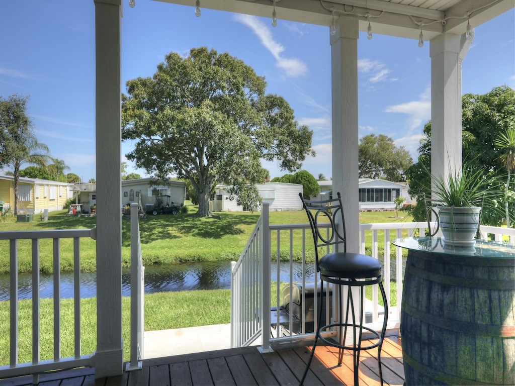 1011 Barefoot Circle Barefoot Bay, FL 32976 - Photo 6 of 31 a view of a porch with chairs and backyard