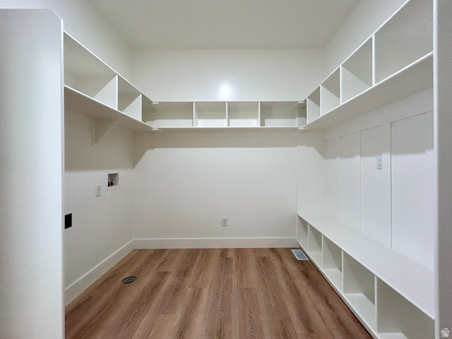 6 South 450th West Gunnison, UT 84634 - Photo 14 of 45 Spacious utility room featuring extensive built-in shelving, wood-finish flooring, and crisp white walls