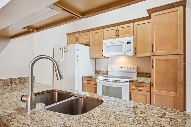a kitchen with a refrigerator sink and stove