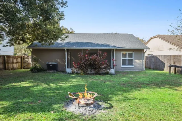 a backyard of a house with table and chairs