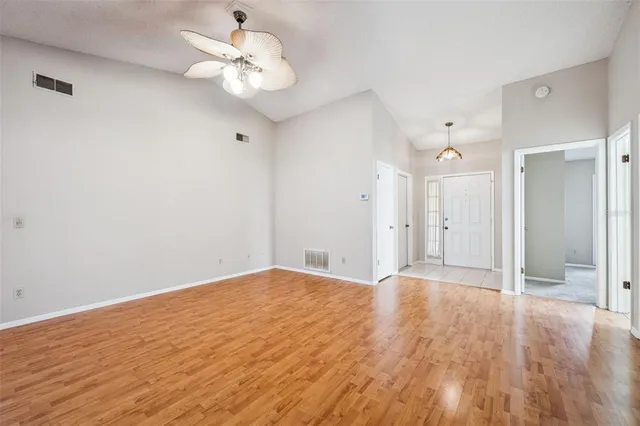 a view of an empty room with a ceiling fan