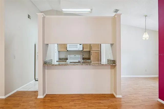 a kitchen with stainless steel appliances a refrigerator and a stove top oven
