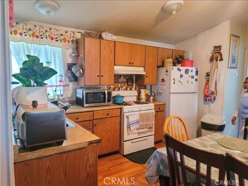 2500 North State Highway 59, Unit 278 Merced, CA 95348 - Photo 12 of 25 a kitchen with stainless steel appliances granite countertop a refrigerator and a stove top oven