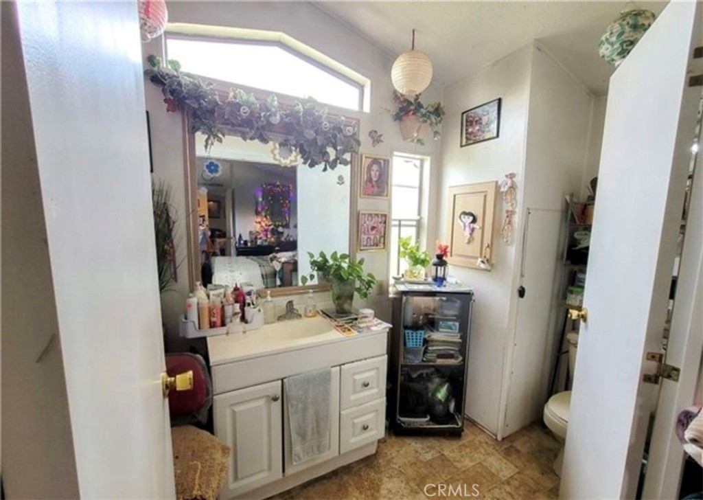 2500 North State Highway 59, Unit 278 Merced, CA 95348 - Photo 18 of 25 a bathroom with a sink a toilet and a mirror