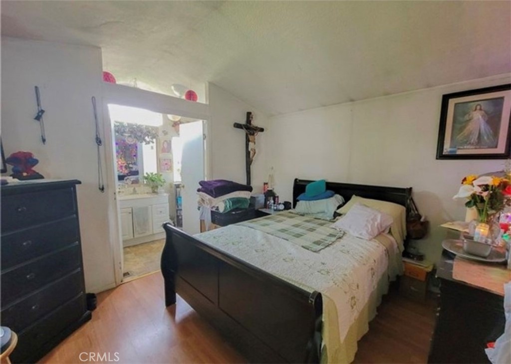 2500 North State Highway 59, Unit 278 Merced, CA 95348 - Photo 20 of 25 a bedroom with bed and a potted plant