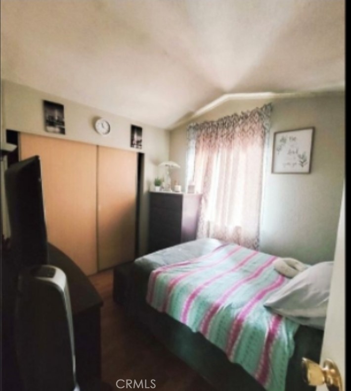 2500 North State Highway 59, Unit 278 Merced, CA 95348 - Photo 22 of 25 a bedroom with a bed and a refrigerator
