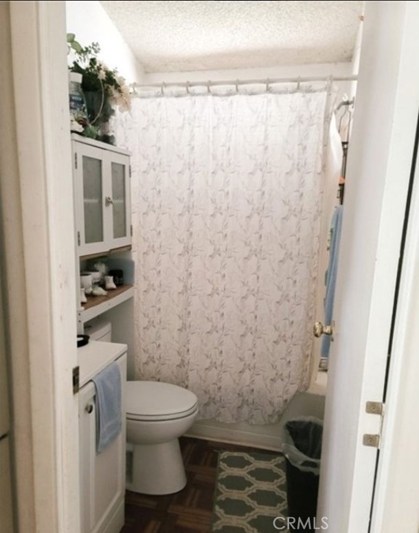 2500 North State Highway 59, Unit 278 Merced, CA 95348 - Photo 23 of 25 a bathroom with a toilet and a shower curtain