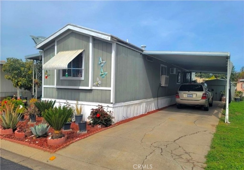 2500 North State Highway 59, Unit 278 Merced, CA 95348 - Photo 24 of 25 a front view of a house with a yard and garage