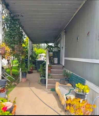 a view of a patio with table and chairs potted plants with wooden fence