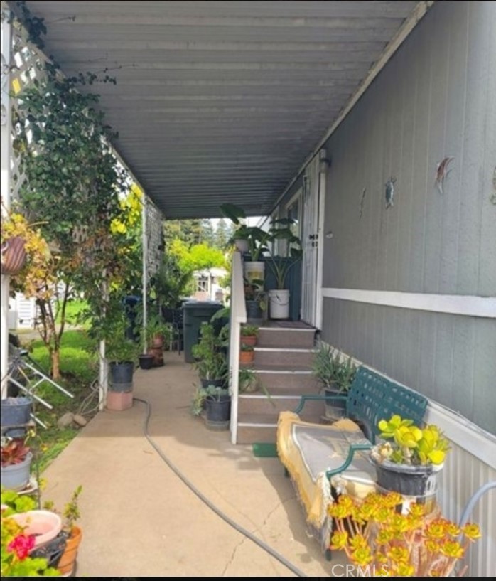 2500 North State Highway 59, Unit 278 Merced, CA 95348 - Photo 3 of 25 a view of a patio with table and chairs potted plants with wooden fence