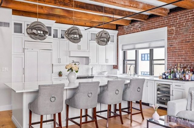 a kitchen with stainless steel appliances granite countertop a sink and cabinets