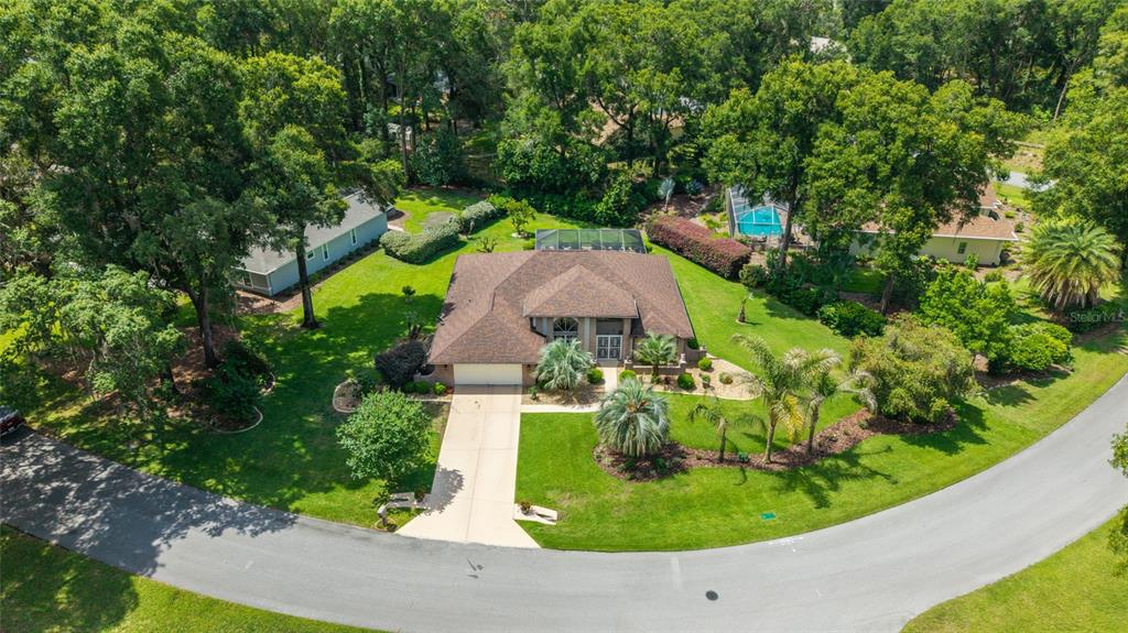 18825 Southwest 93rd Loop Dunnellon, FL 34432 - Photo 3 of 85 an aerial view of a house with a garden and trees