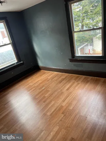 a view of an empty room and wooden floor