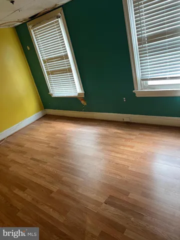 a view of a room with wooden floor and a window
