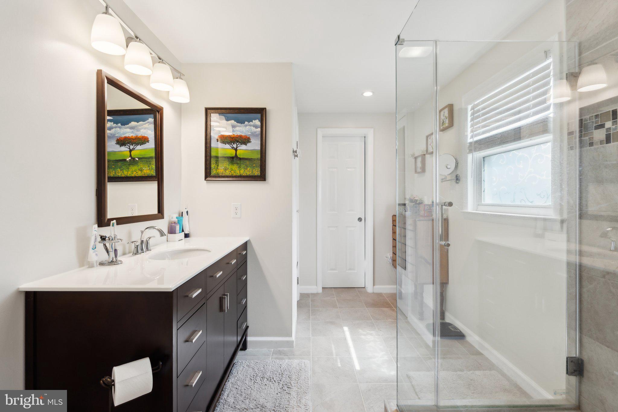 220 Lamphier Street Culpeper, VA 22701 - Photo 22 of 51 a spacious bathroom with a double vanity sink a mirror and a shower