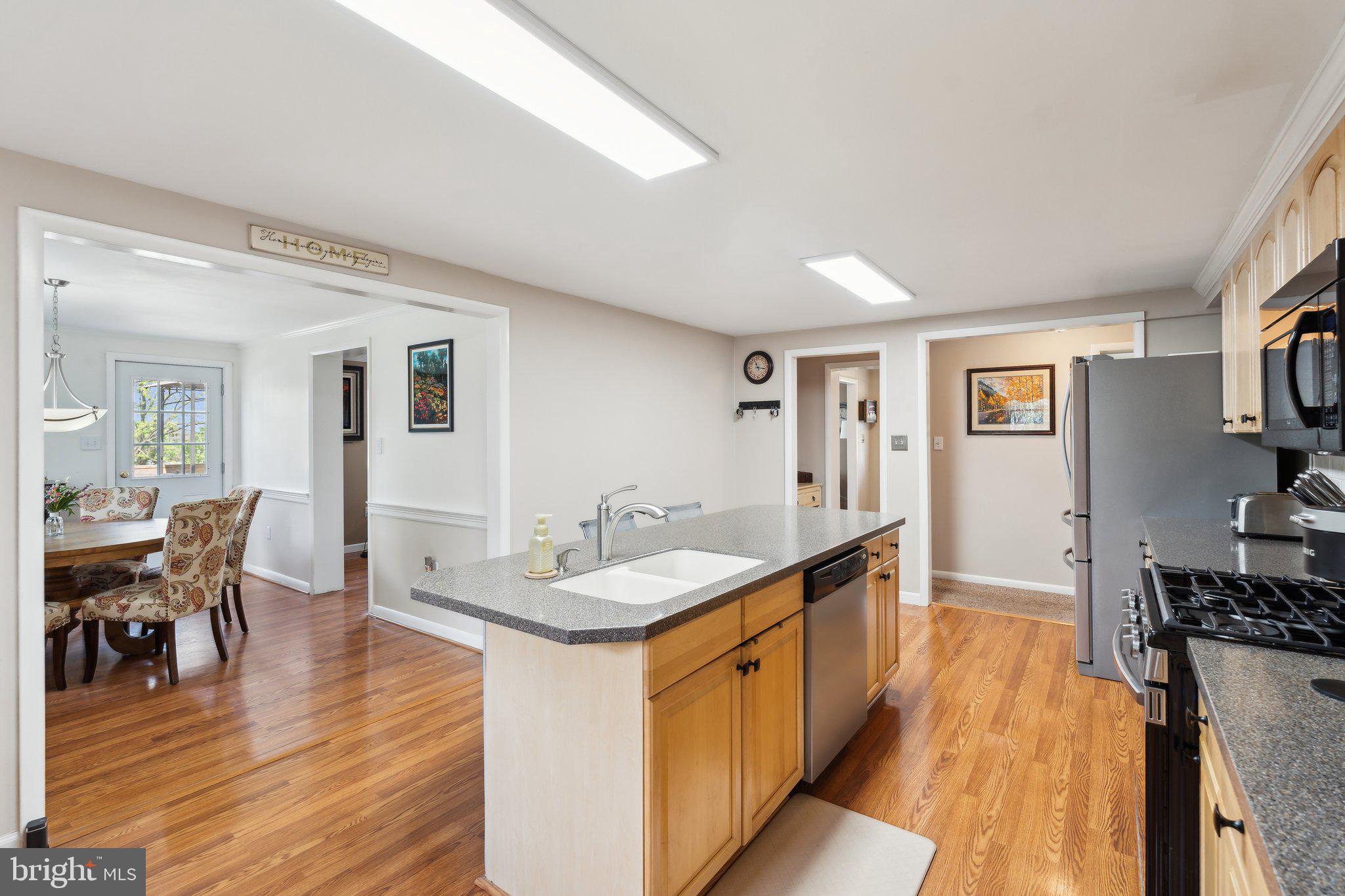 220 Lamphier Street Culpeper, VA 22701 - Photo 9 of 51 a dining hall with stainless steel appliances granite countertop a sink and wooden floor