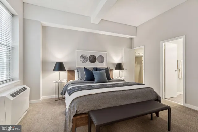 a bedroom with a bed and a table with mirror