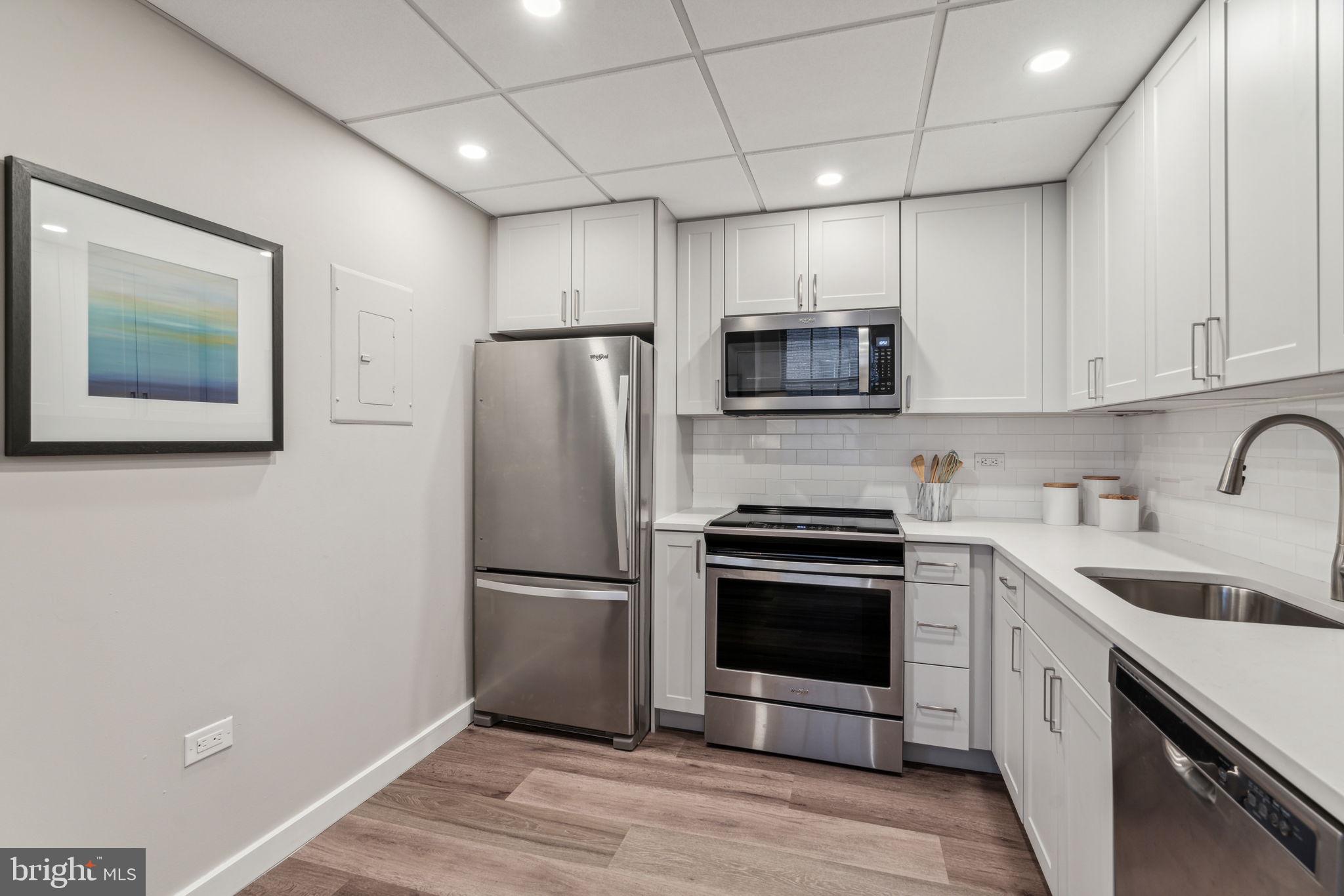 875 Sansom Street, Unit 630 Philadelphia, PA 19107 - Photo 10 of 35 a kitchen with a sink stainless steel appliances and cabinets