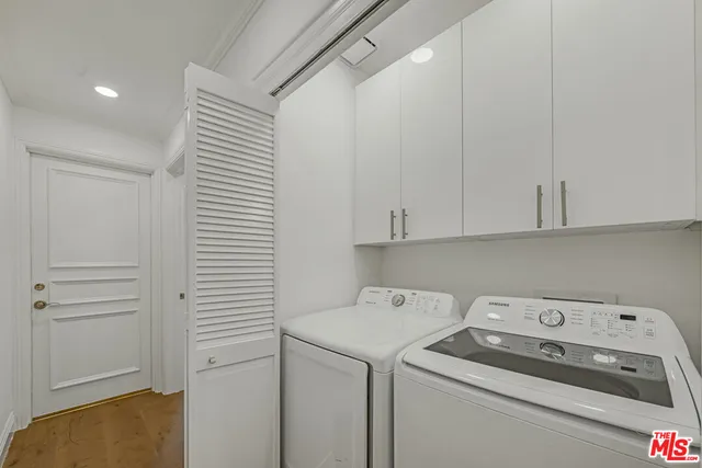 a view of storage and utility room with washer and dryer
