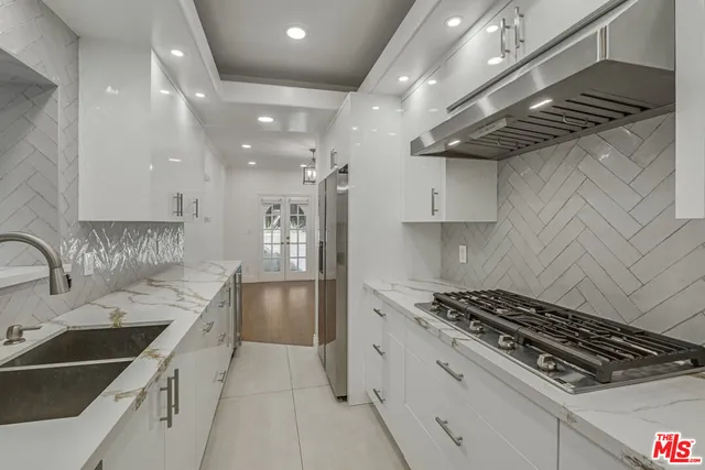 a kitchen with a sink stove and refrigerator