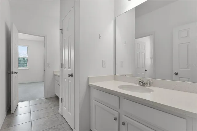 a bathroom with a granite countertop toilet a sink and shower
