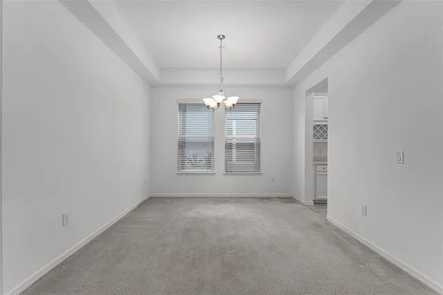 a view of a room with windows and chandelier