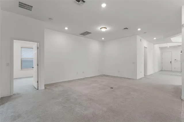 an empty room with a empty space and windows