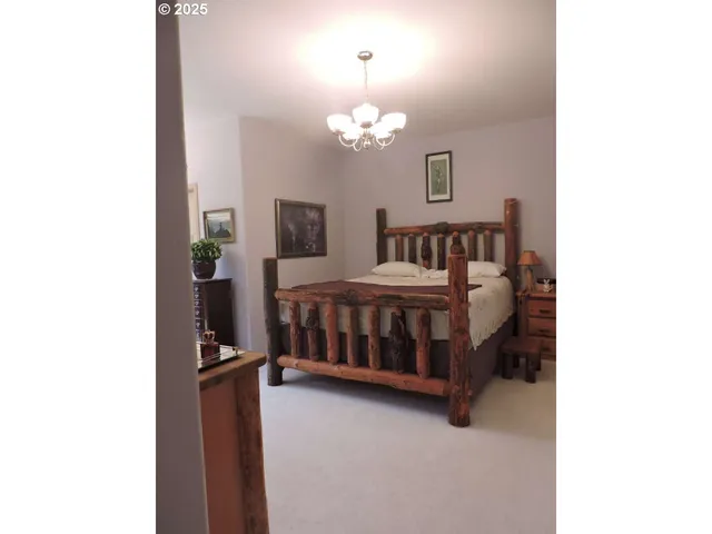 a bedroom with a bed and a chandelier