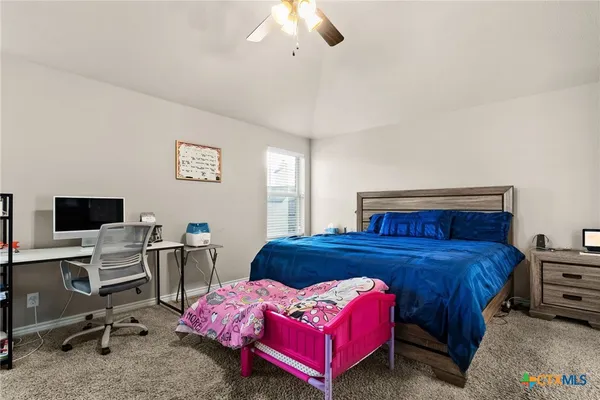 a bedroom with a bed and a desk