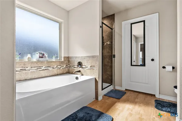 a bathroom with a sink a mirror and a bathtub