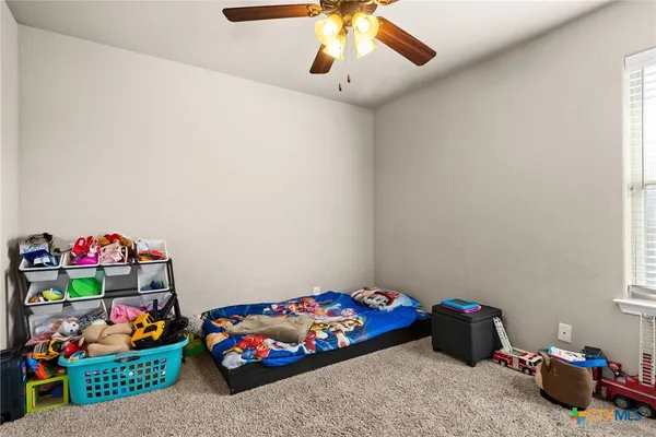 a bedroom with toys and dresser