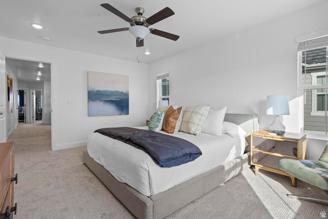 488 West Greenstone Pl Street, Unit 1010 St. George, UT 84790 - Photo 23 of 34 Spacious bedroom featuring light neutral carpet, white walls, and a contemporary ceiling fan with integrated lighting