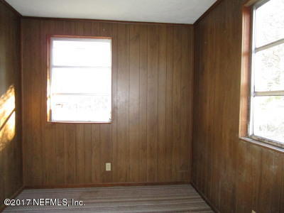 54207 Hurst Road Callahan, FL 32011 - Photo 11 of 12 a view of an empty room with wooden floor and a window