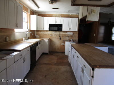 54207 Hurst Road Callahan, FL 32011 - Photo 3 of 12 a kitchen with granite countertop a sink and a stove