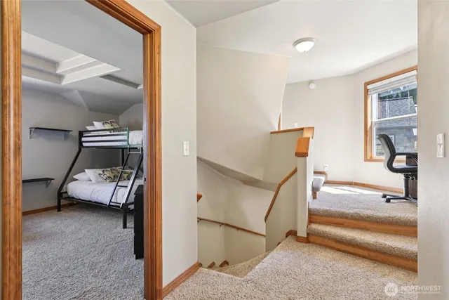 a view of a workspace with furniture and wooden floor