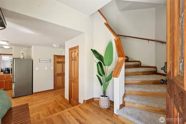 a view of entryway with wooden floor and stairs