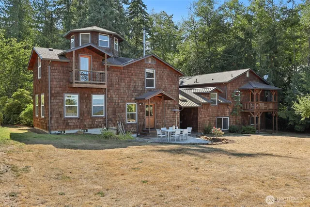a view of a patio with a table chairs and a fire pit