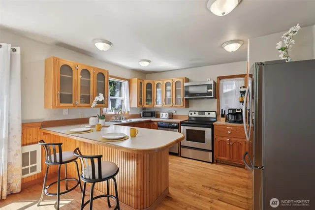 a kitchen with stainless steel appliances granite countertop a stove and a refrigerator