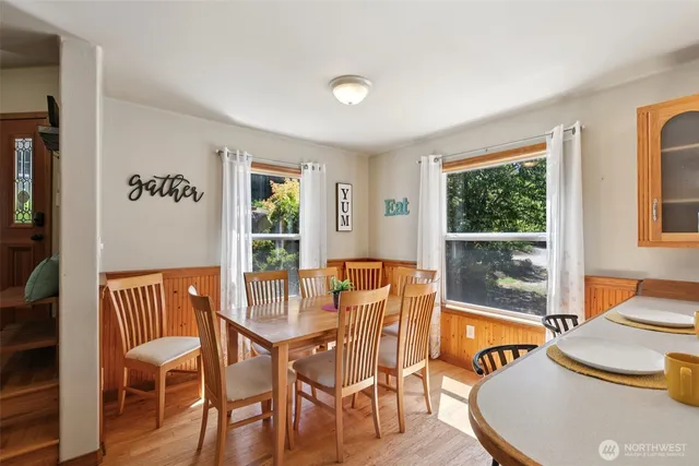 a dining room with furniture and wooden floor