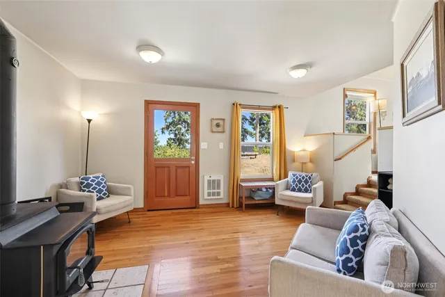 a living room with furniture and wooden floor