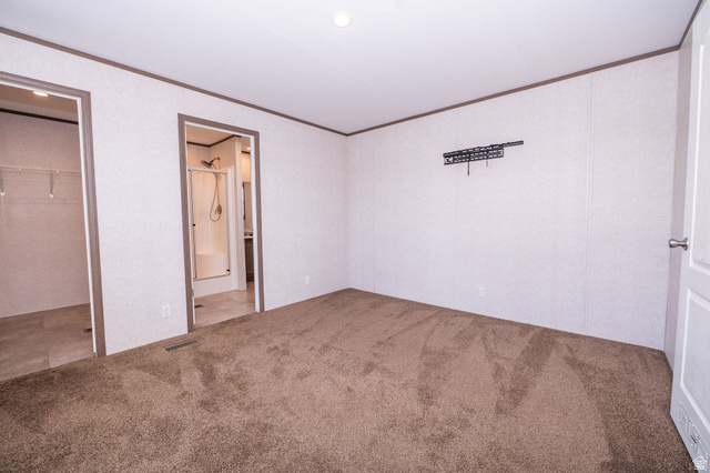 2491 Highway 89, Unit 403 Pleasant View, UT 84404 - Photo 17 of 32 Spacious room with plush brown carpeting and white walls