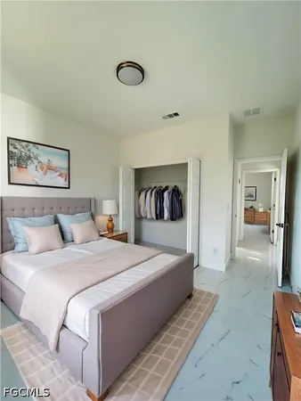 a bedroom with a large bed and a chandelier