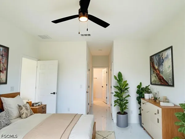 a bedroom with a bed and a potted plant