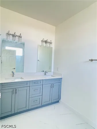 a spacious bathroom with a double vanity sink and a mirror