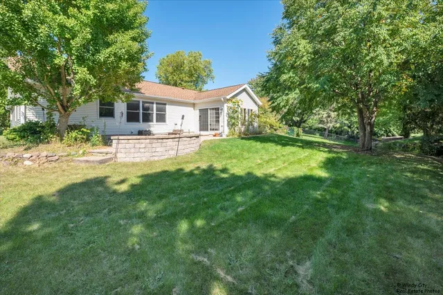 a front view of house with yard outdoor seating and barbeque oven